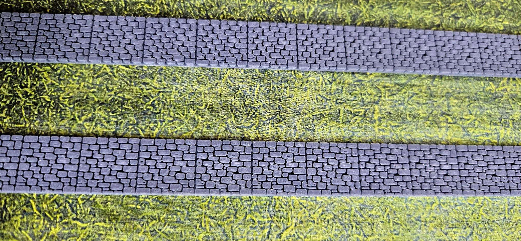 Angled view of N scale stone fence walls